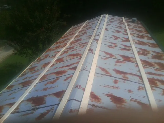 Rusted metal roof panels with new wood purlins before replacement — Storm Damage Roof Repair in Stony Creek by Roofing Brothers