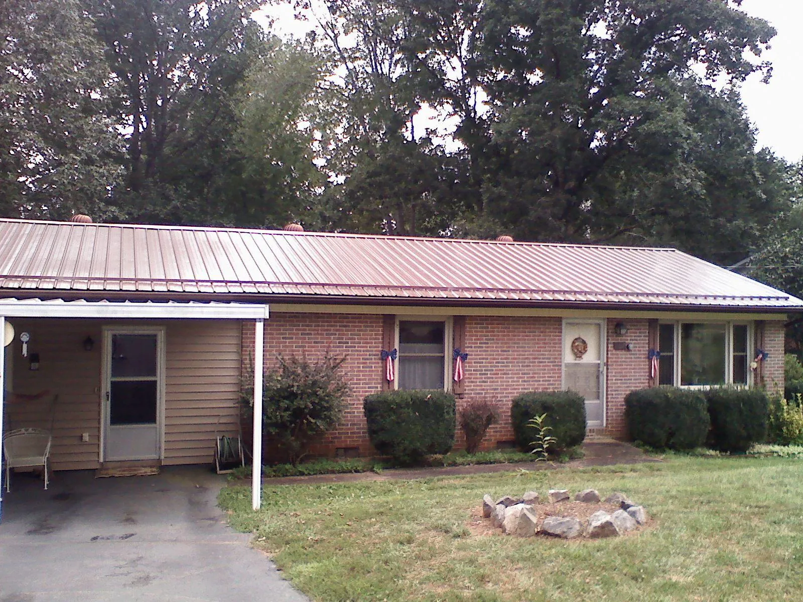 Bronze metal roof and carport on a brick ranch home — Roof Repair work by our crew in Stony Creek